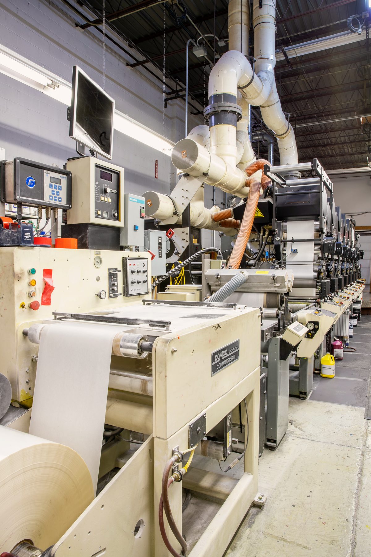 Narrow-web flexographic label press at Bell Litho, Inc., running a roll of label stock
